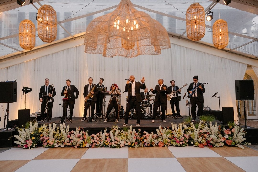 Set the stage for a perfect weekend! 🤍
.
.
.
#bandbackdrop #setthestage #weddingdetails #weddingband #weddingfabric #tentedreception #dancefloor #fridayfeels #weekendready #gableendcurtains #peakedcurtains #ivoryvalance #rattanlighting #floralstages