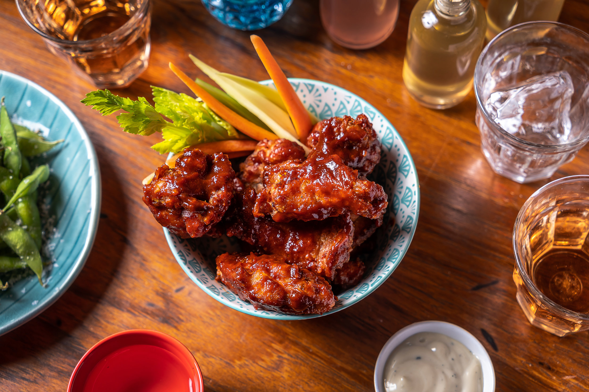 fried chicken wings in a bowl with pickled vegetables 