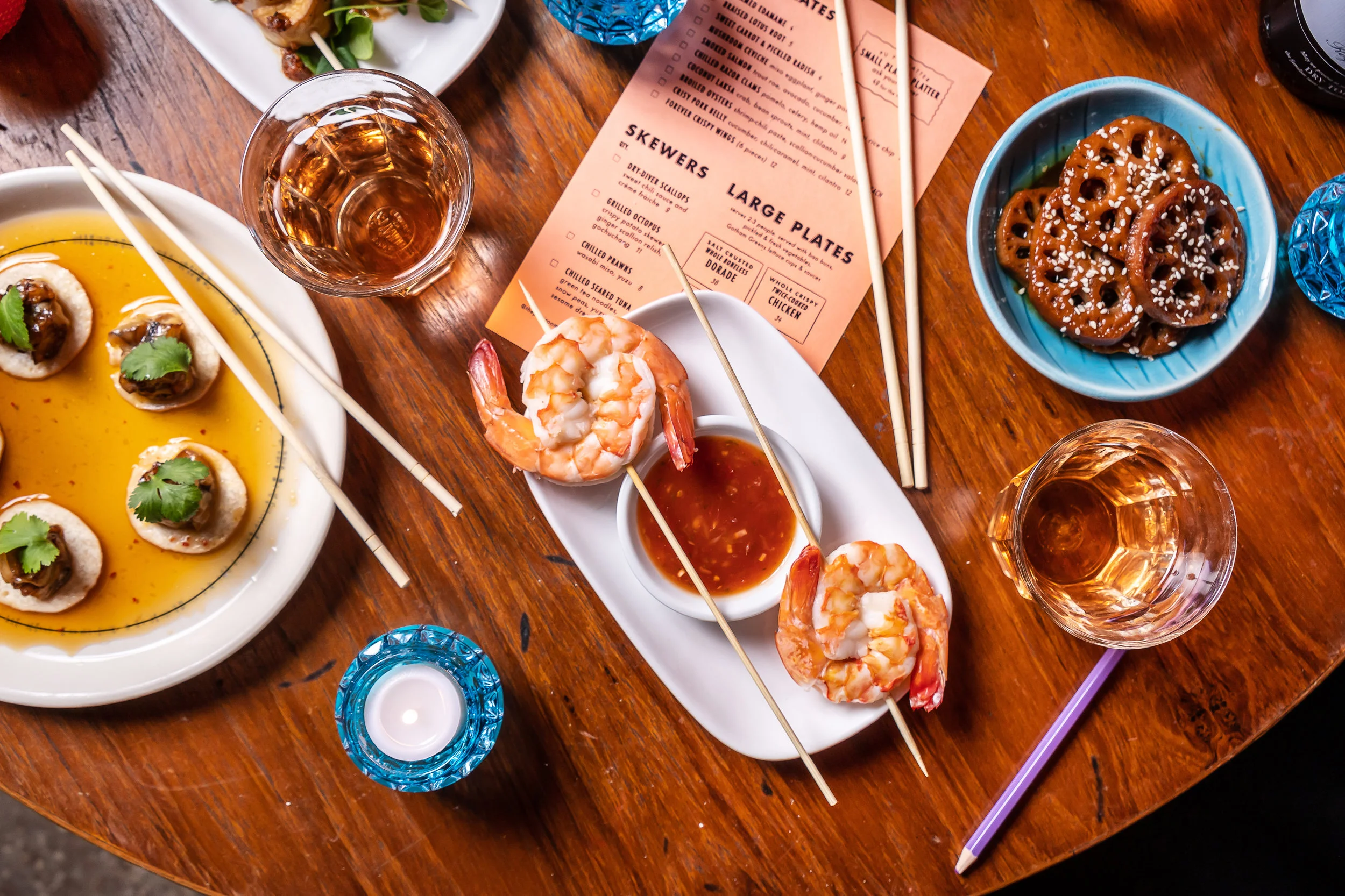 shrimp skewers, lotus root, and glasses of wine 