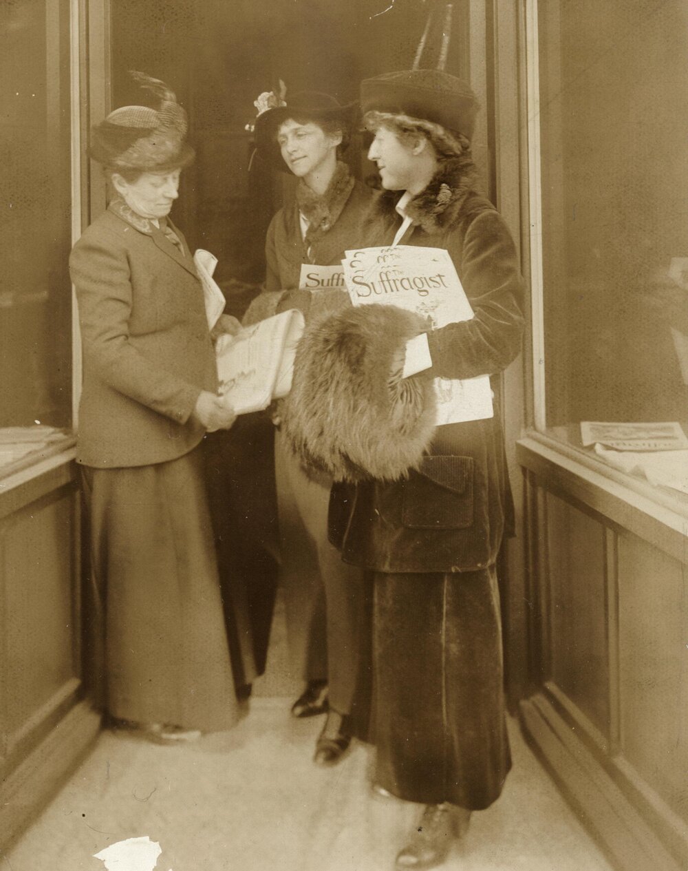 Jeannette Rankin (right) holding The Suffragist newspaper   (Library of Congress)