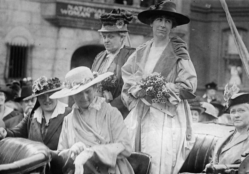 Jeannette Rankin (standing right) and Carrie Chapman Catt (standing left)   (Library of Congress)