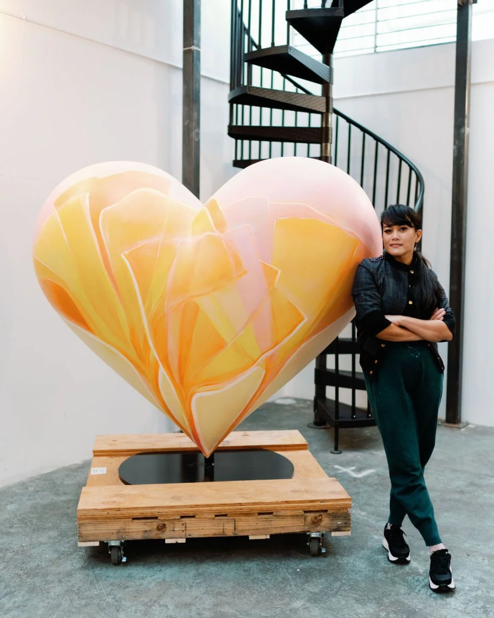 Dev Heyrana with her SŌL heart sculpture in her studio at Ciel Creative Space in Berkeley, California, for the San Francisco General Hospital Foundation