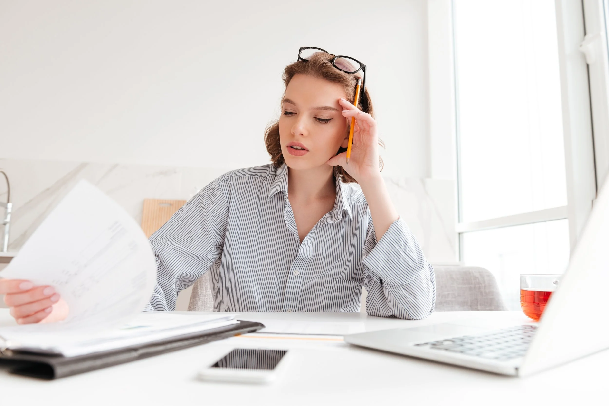 close-up-portrait-serious-businesswoman-holding-her-head-while-working-with-documents-light-apartments (1).jpg
