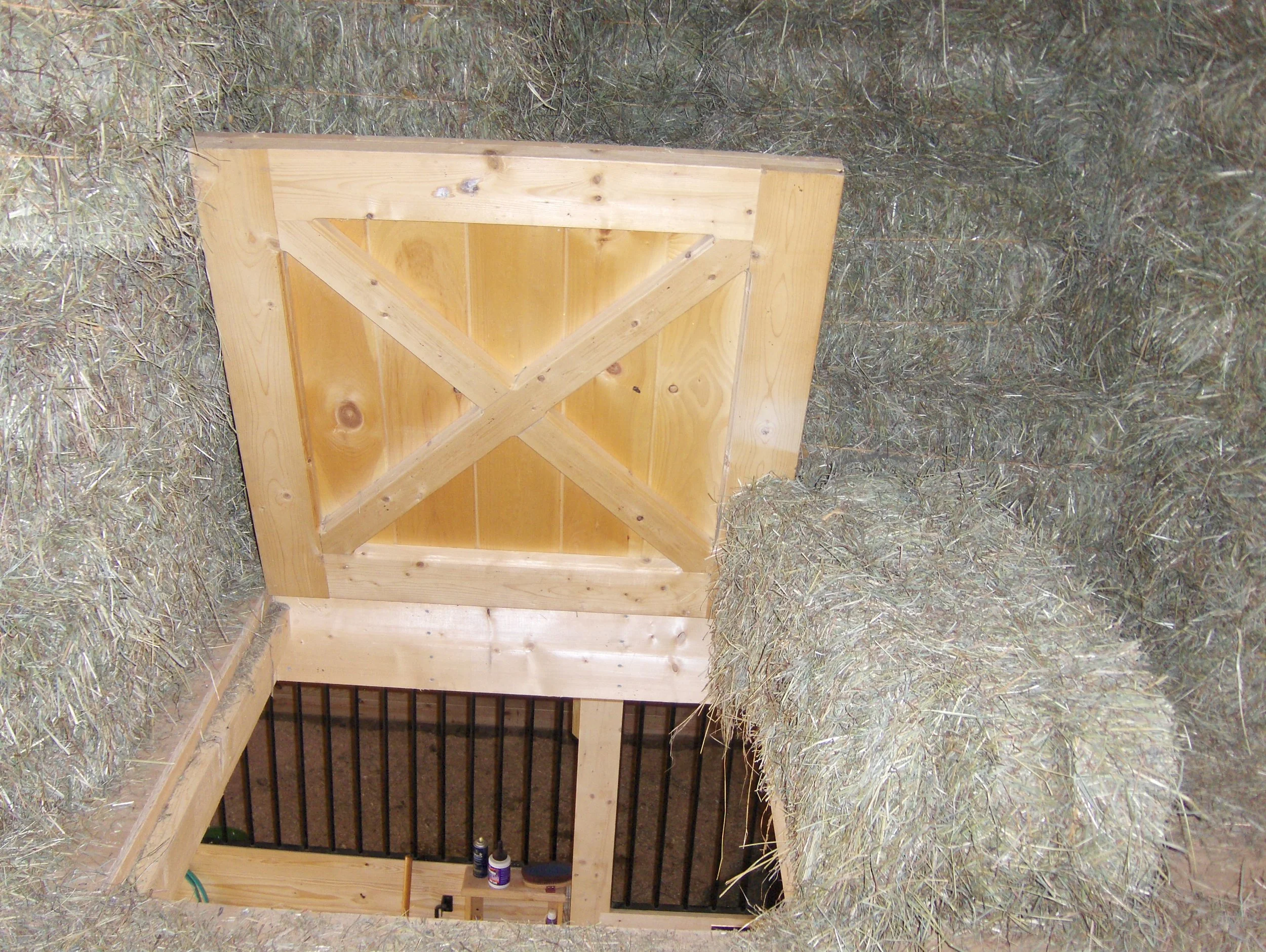  Hay drop door surrounded by bales of hay 
