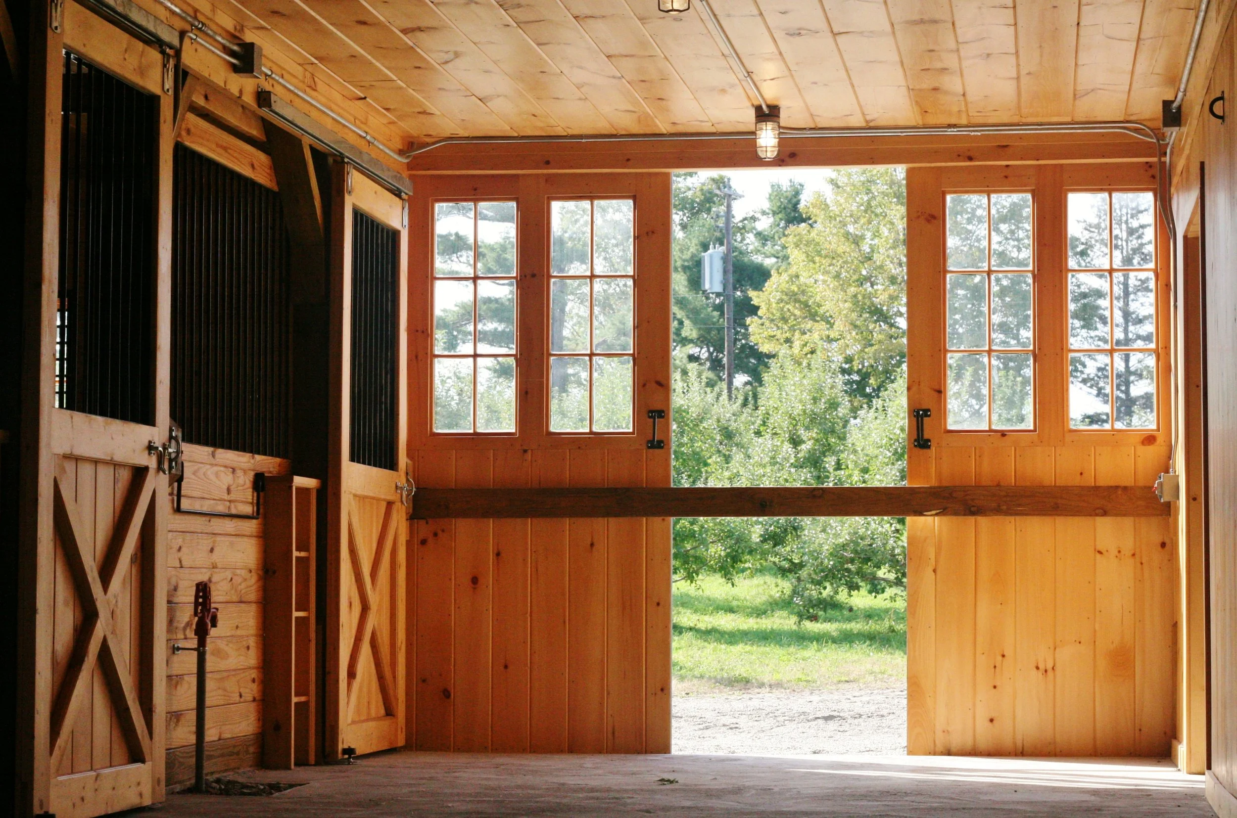 Stalls and gable end split sliding door at Apple Crest Horse Barn 