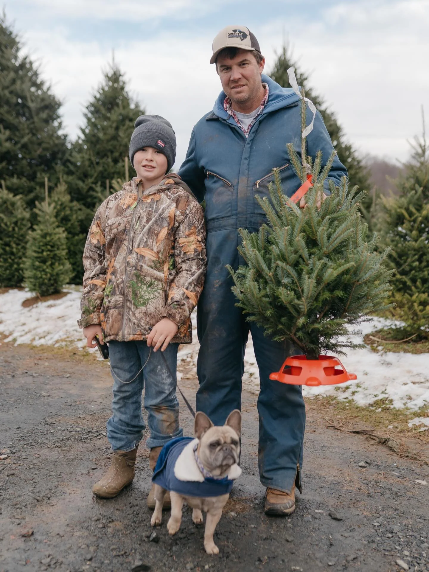 Adam Keith and his son pose with their Christmas tree at Frosty&rsquo;s Choose-and-Cut.