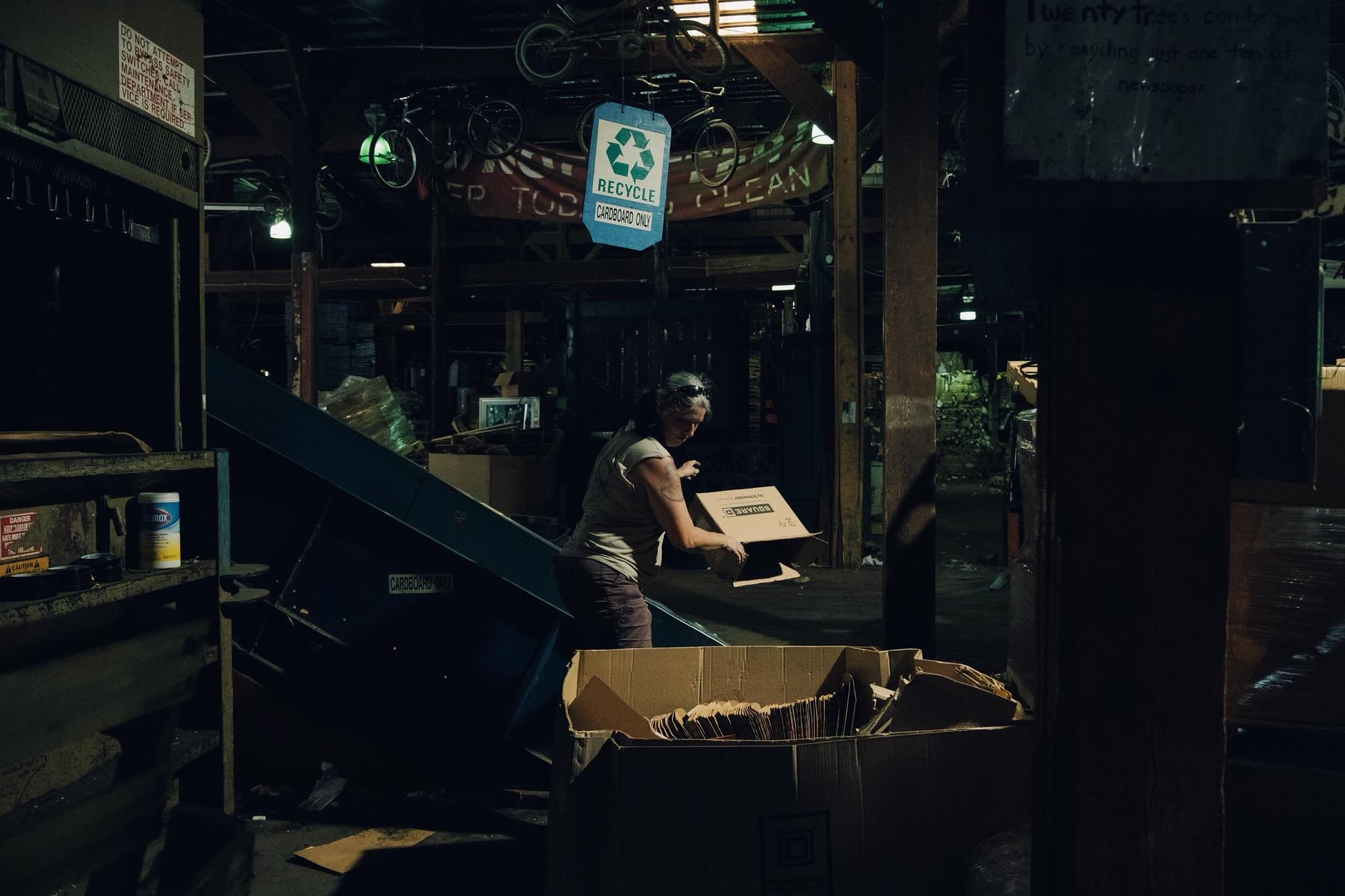 Cynthiana, KY, 2022. Donna (Franklin) Strausbaugh, 46, loads a cardboard baling machine in Randy&rsquo;s Odd Jobs and Recycling Center in Cynthiana, KY on River Rd on July 5, 2022. Strausbaugh took this job two months ago with her friend that works w
