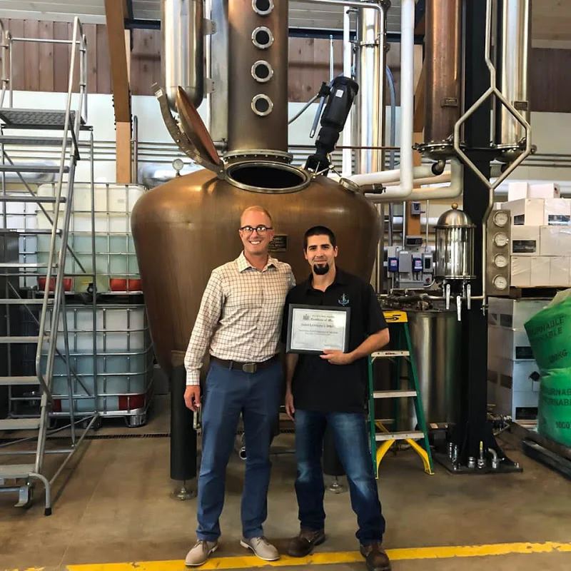 NYS Assemblyman Mark Walczyk and Head Distiller Bill Garrett with the Certificate of Merit.