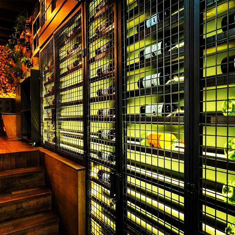 Blast from the past. The wines of restaurant &lsquo;de With&rsquo; behind bars. Realised in 2018. #barlights #winestorage #winedisplay #hositalitydesign #bardesign #restaurantdesign #winelight #wineshelves #winecabinet