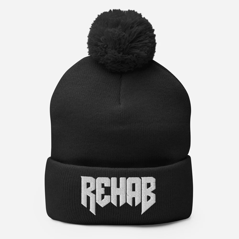 pom-pom-knit-cap-black-front-61a7ad537b420.jpg