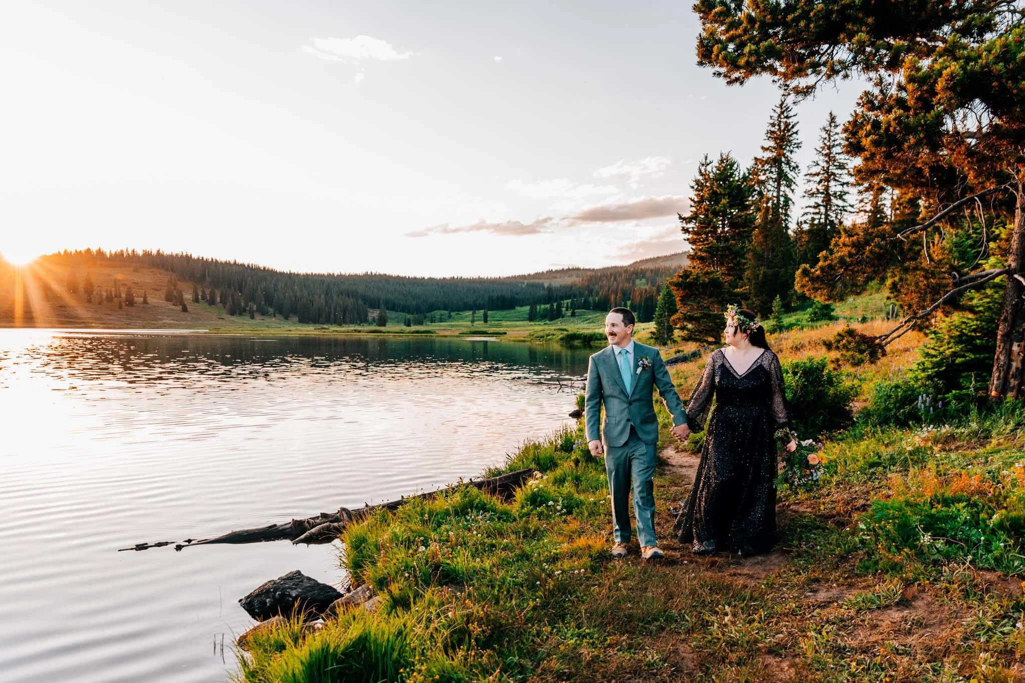 couple eloping at sunrise on an alpine lake in colorado