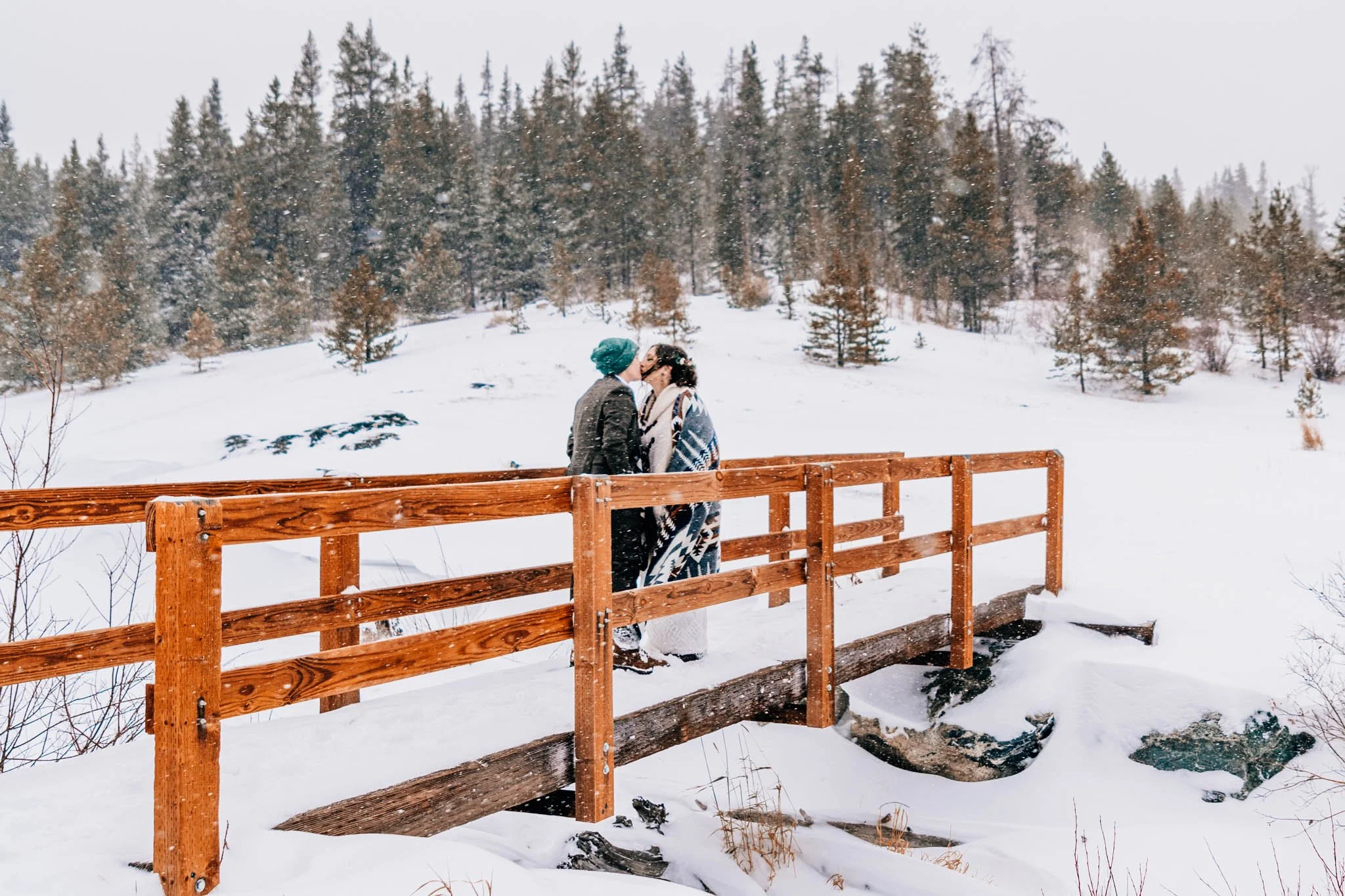 Couple eloping in a snowstorm december winter elopement breckridge