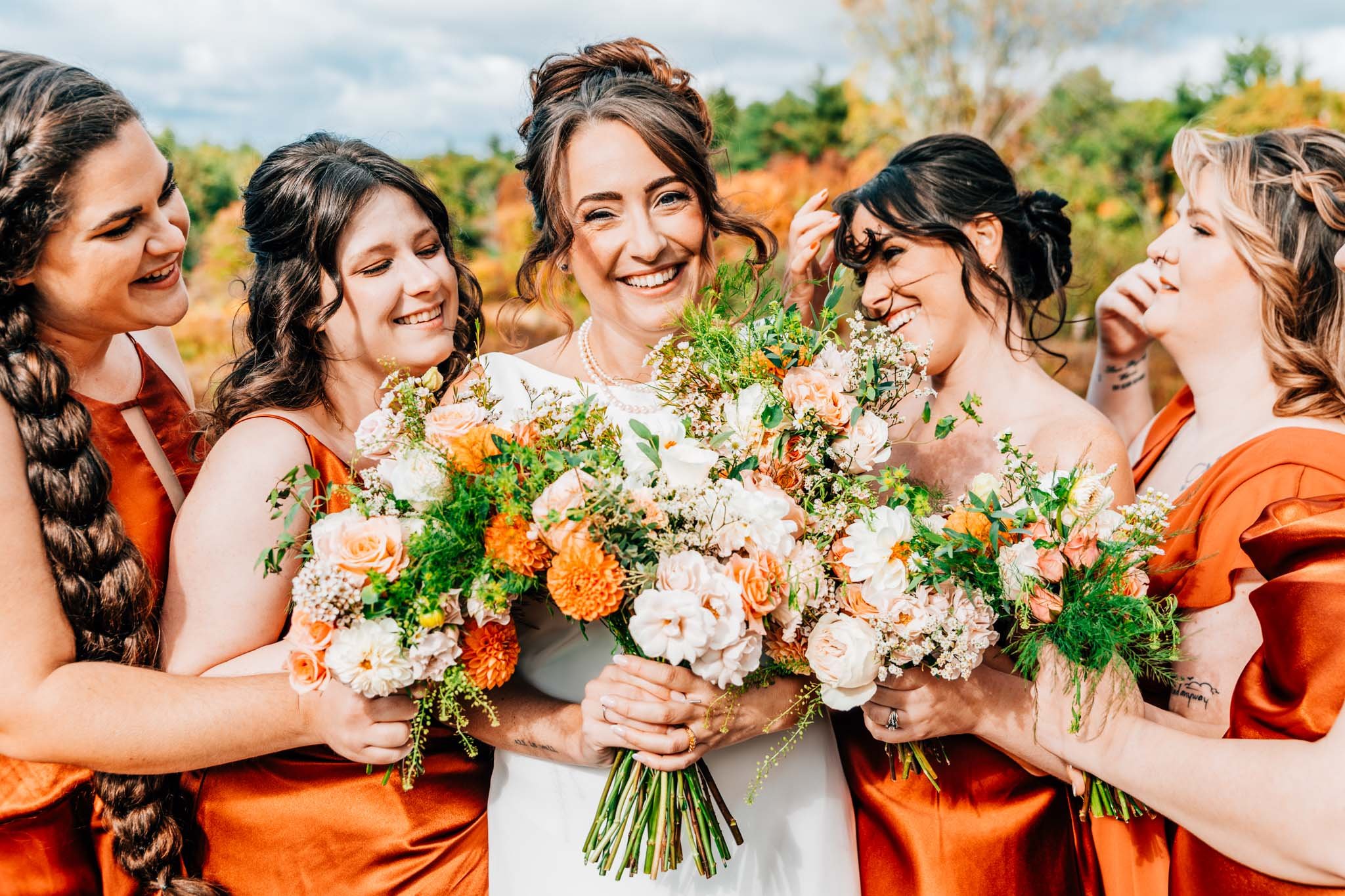 Colorado floral designer, bridal party holding up their bouquet