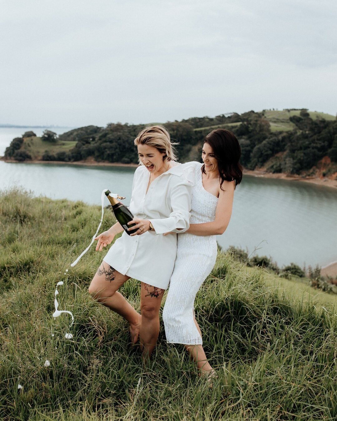 Hannah and Kelsey poppin' bottles.⠀⠀⠀⠀⠀⠀⠀⠀⠀
⠀⠀⠀⠀⠀⠀⠀⠀⠀
Had the besssst afternoon with these two, exploring paddocks, hills and waterfronts after their intimate elopement on Waiheke Island. Absolute legends.⠀⠀⠀⠀⠀⠀⠀⠀⠀
⠀⠀⠀⠀⠀⠀⠀⠀⠀
Hair and makeup by @thepe
