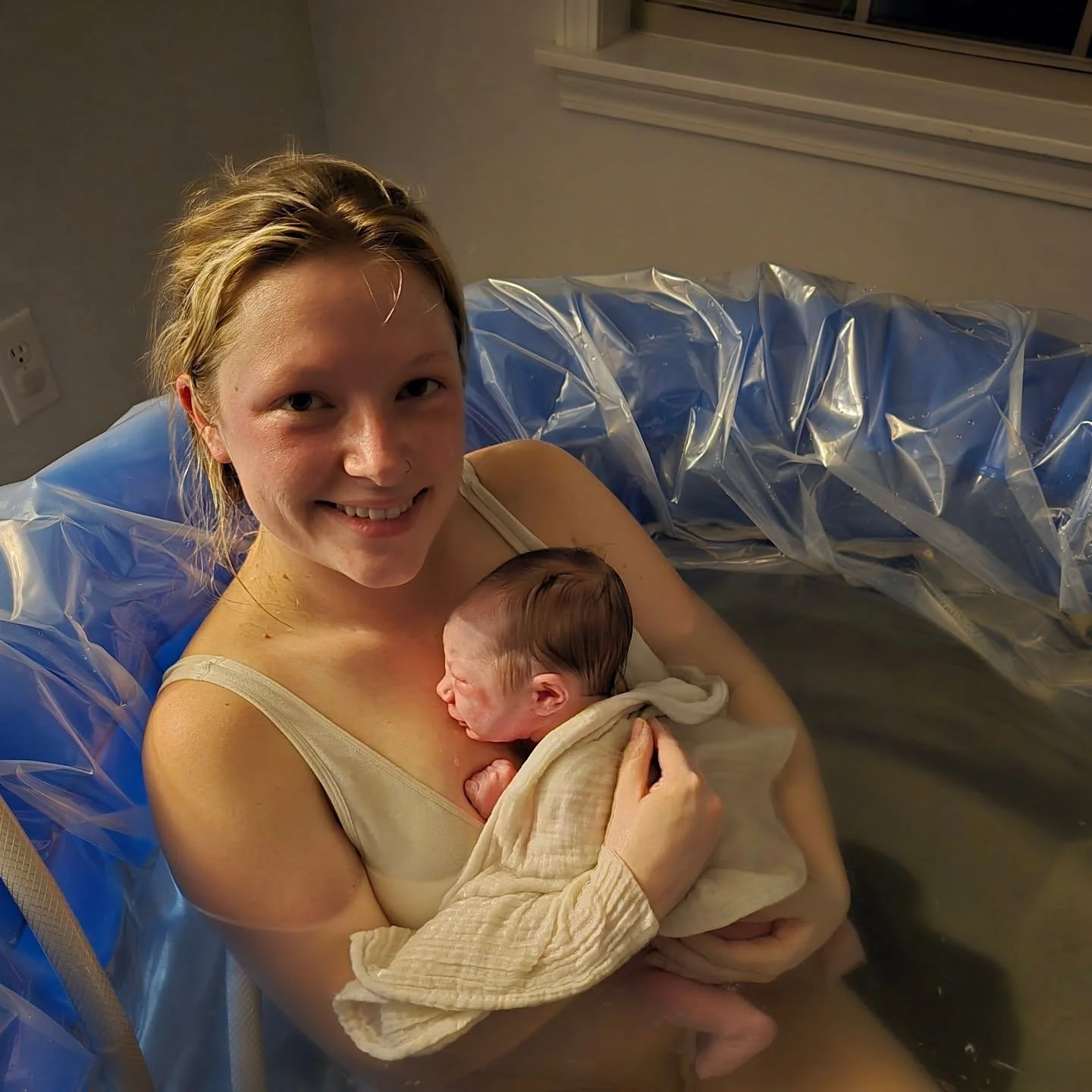 Taken just moments after the baby was born, she was laughing after she pushed his head out (before the rest of his body came). This picture is a better promotion for natural birth, home birth, and water birth than any words. It's proof birth doesn't 