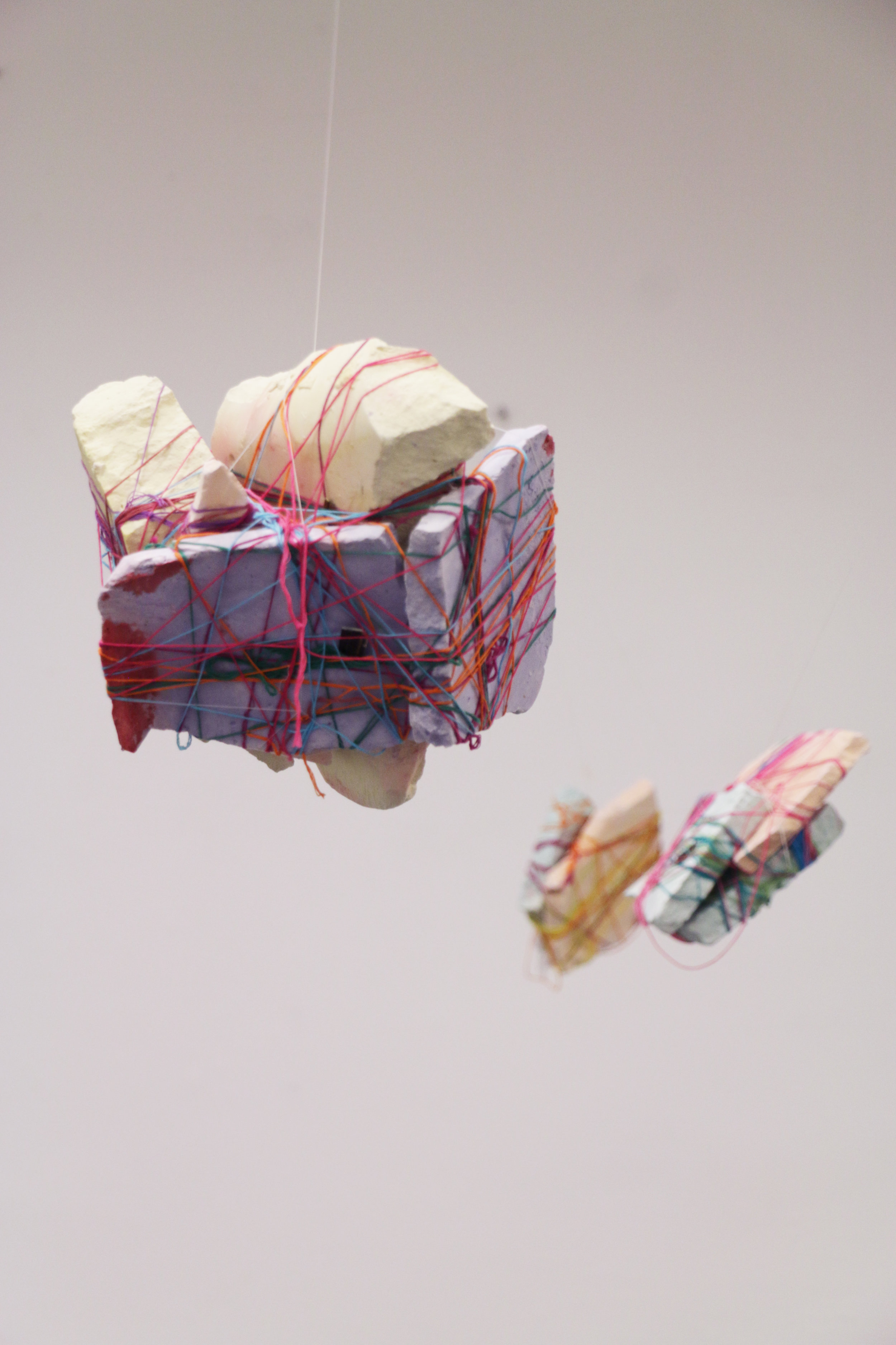   Hanging by a Thread , 2019, plaster and embroidery thread 