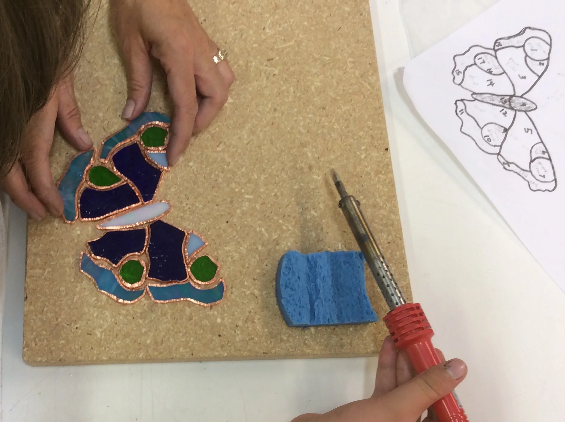 Student working on a Stained Glass Sun Catcher from her original pattern.