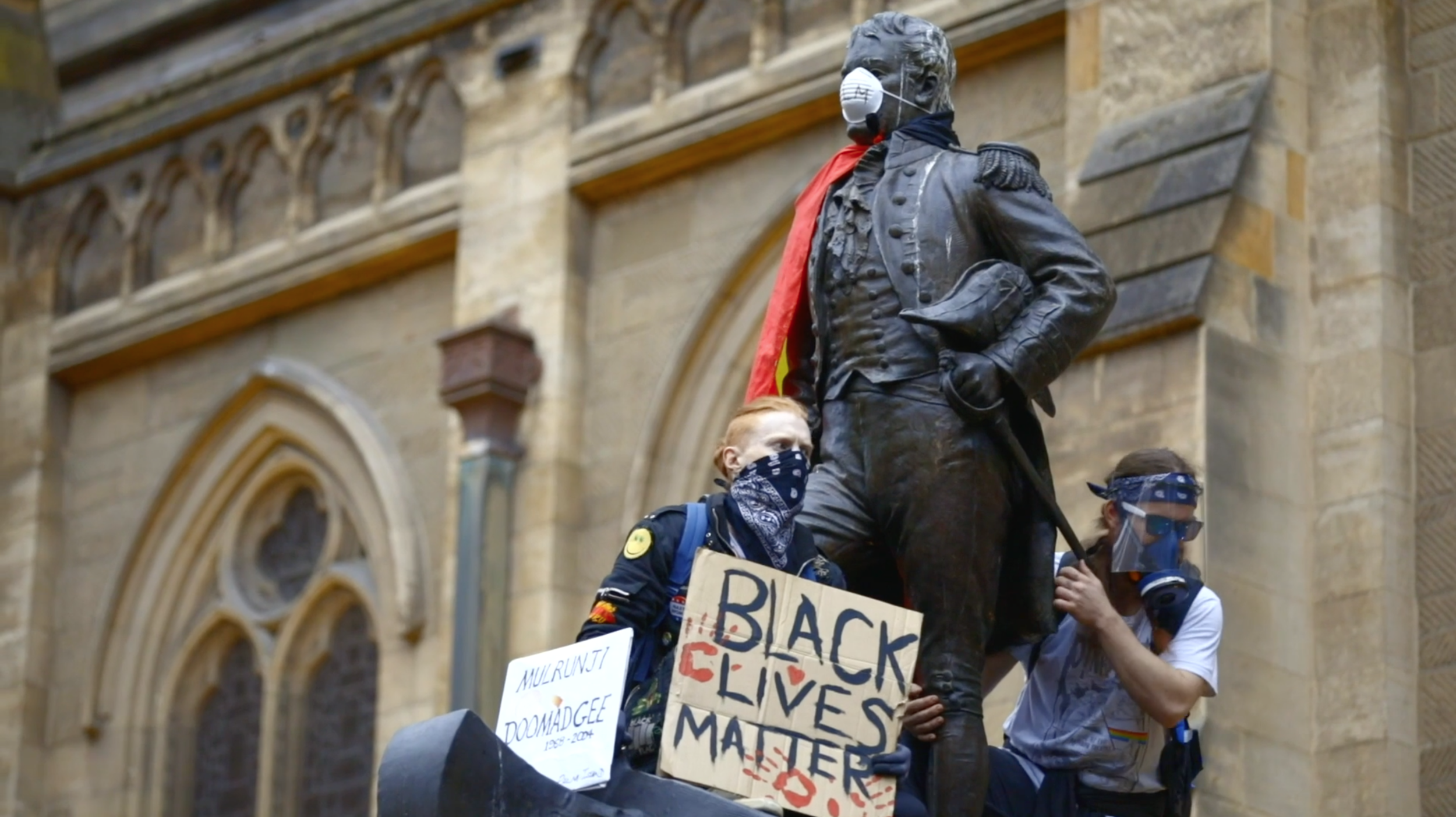  Black Lives Matter protestors climb a statue of Matthew Flinders in Melbourne. Photo: Warwick Jones [ watch video ] 