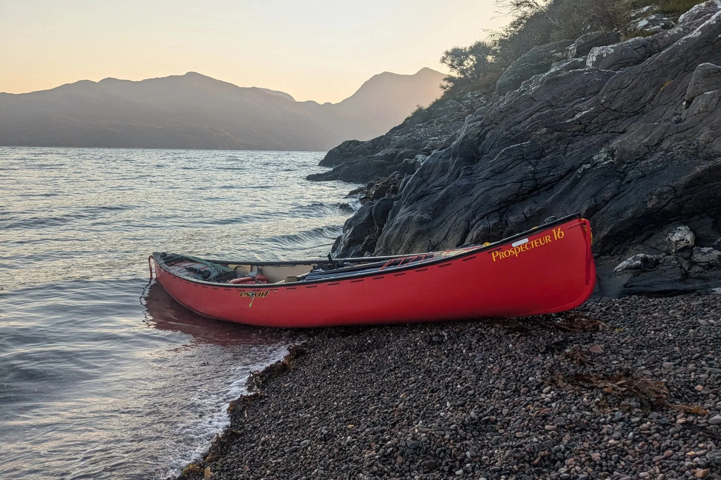 Canoe on the shores of Loch Hourn during a canoe expedition into the Knoydart area of Scotland