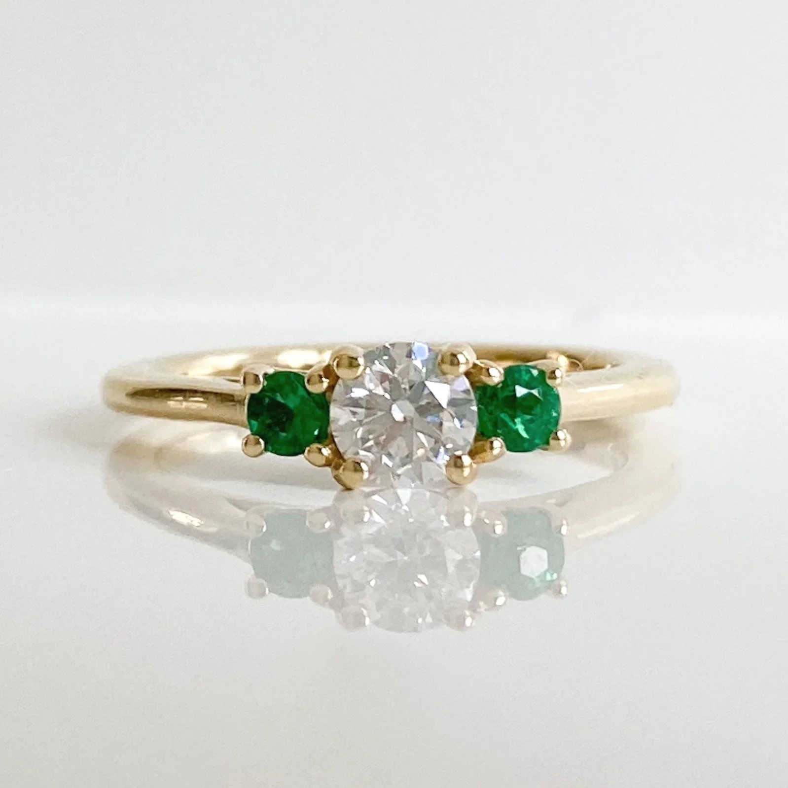 Yellow gold diamond and emerald trilogy
