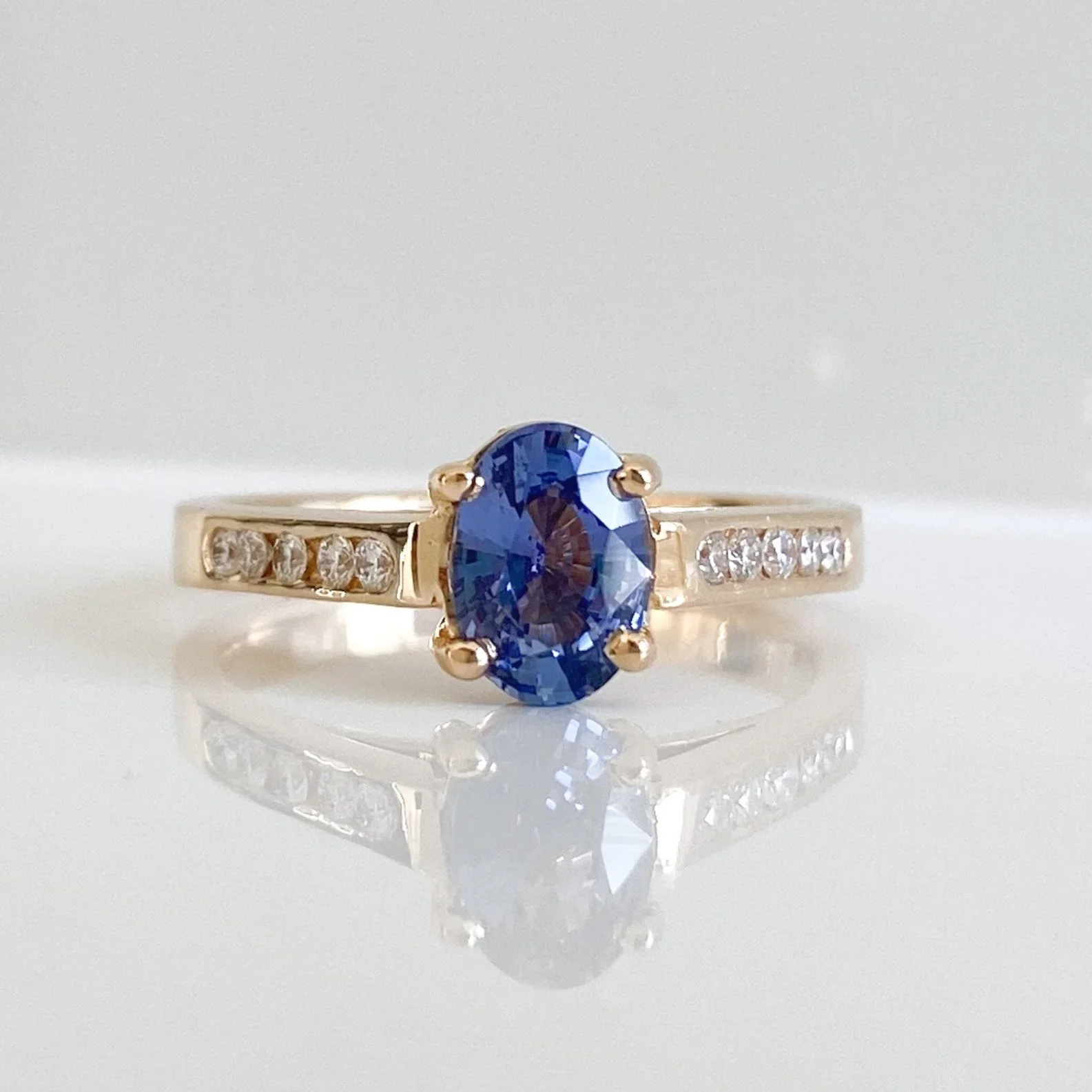 Oval sapphire solitaire with diamond shoulders