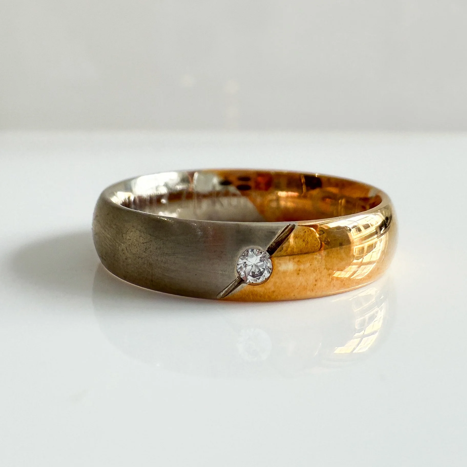 Diamond set gold and titanium band