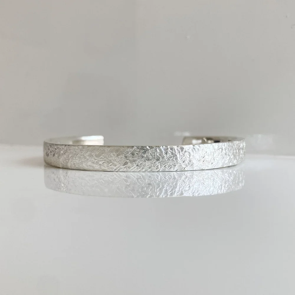 Hammered-finished silver torque bangle