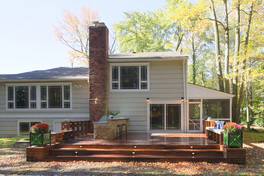 AFTER - EXTERIOR (WE CREATED A NEW DECK WITH AN OUTDOOR KITCHEN AND BUILT-IN BENCHES)