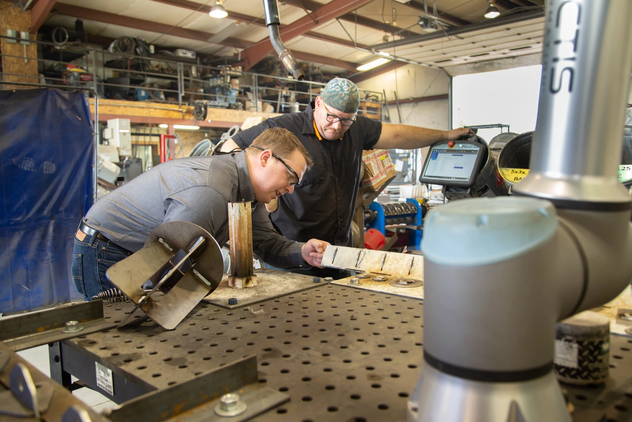 Vectis Automation and MT Solar employees inspect welds