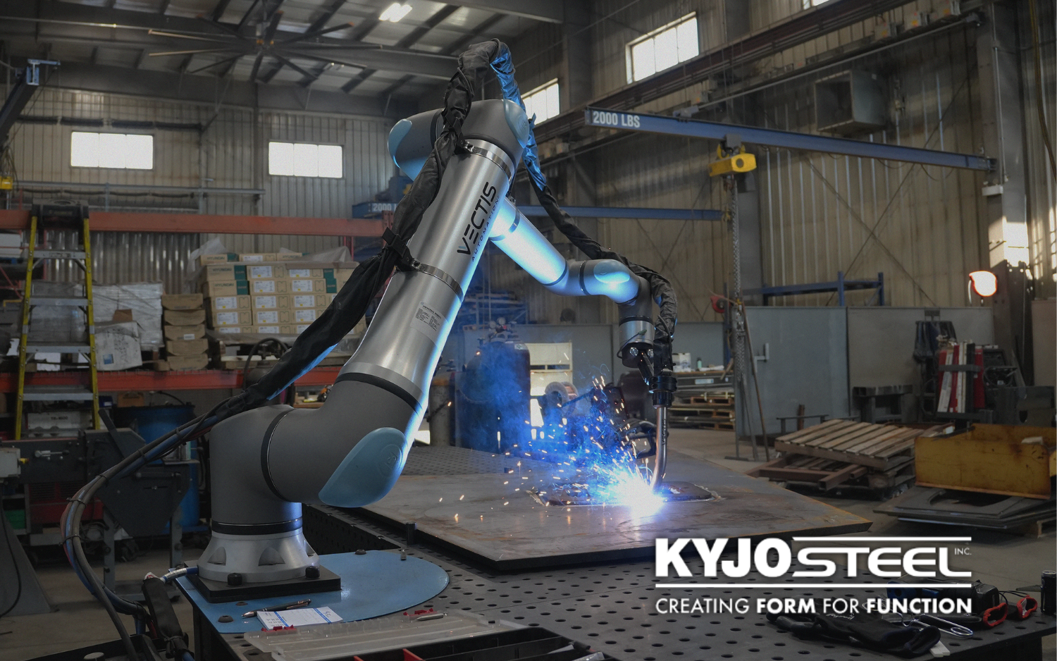 Cobot welding system welding a steel plate at Kyjo Steel.