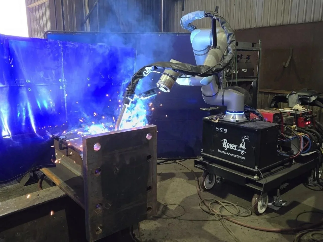 Vectis Rover cobot welding a moment joint at Central Texas Ironworks.