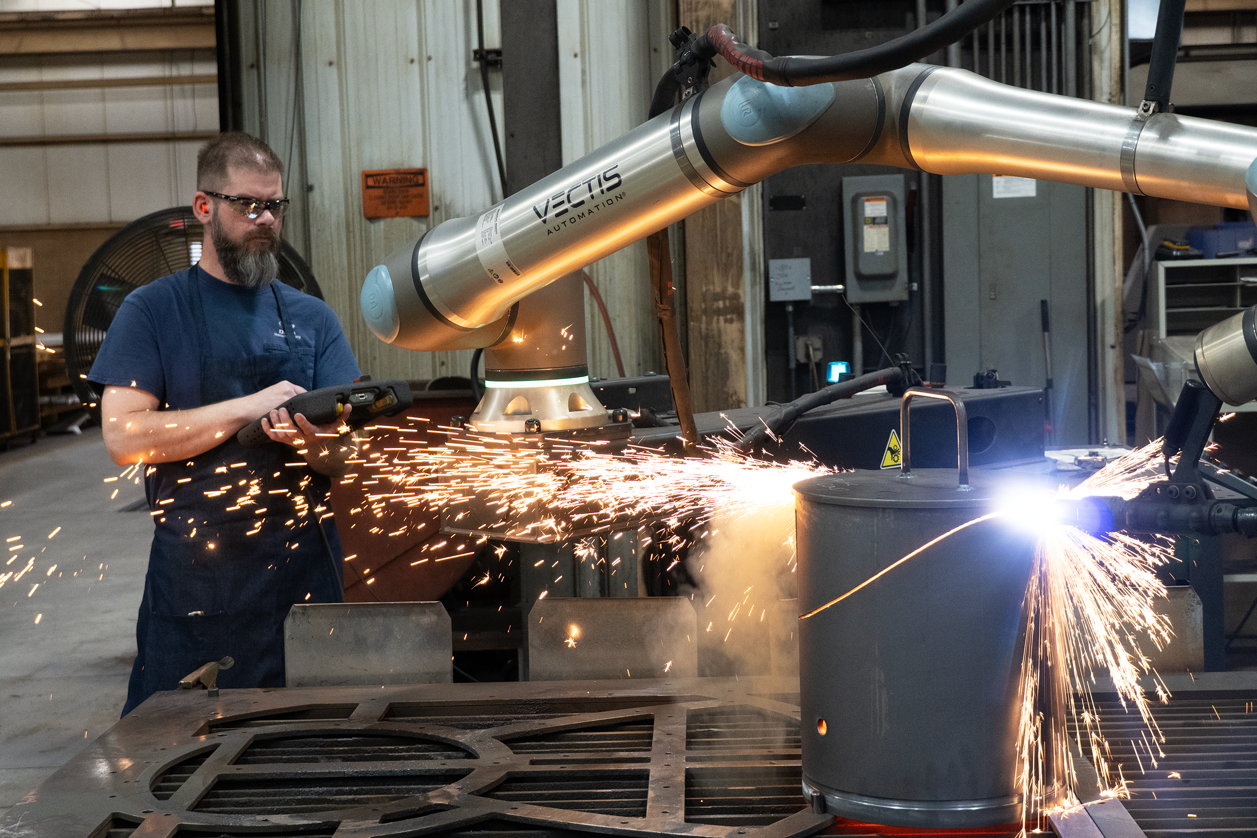 Operator watches Vectis collaborative robotic plasma cutting at D&S Manufacturing