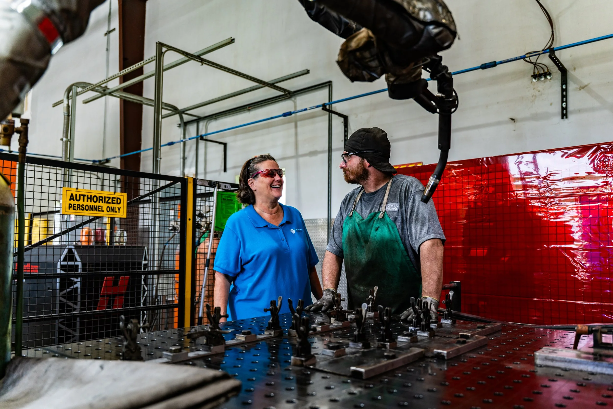 Centerline Brackets owner speaking with welder