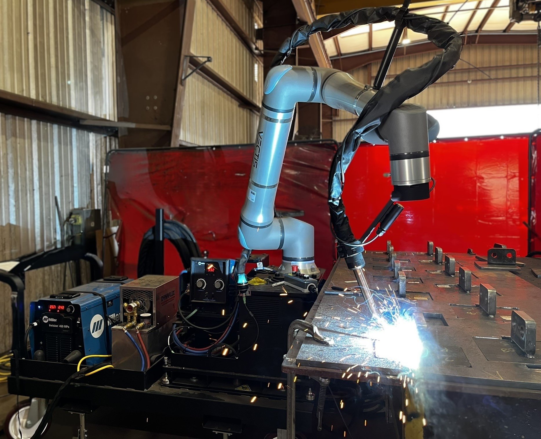 Vectis Rover welding lifting eyes onto a steel plate for equipment fabrication.