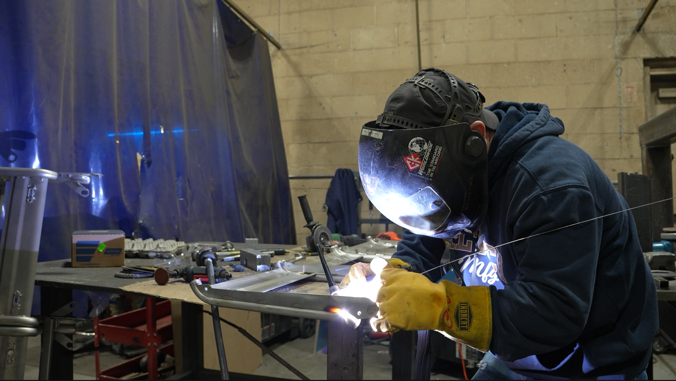 TIG welder welds a part at Caltech Manufacturing