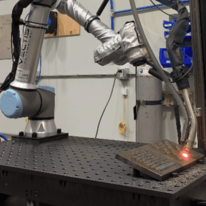 Vectis cobot applying drop carbide to a steel component.
