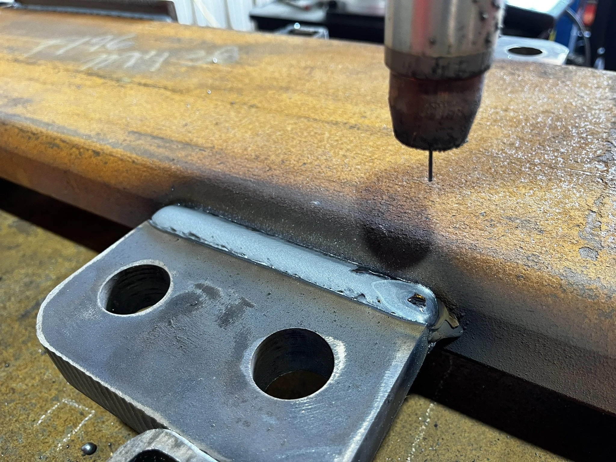 Close-up of a structural steel attachment welded with a cobot at Kennedy Fabricating.