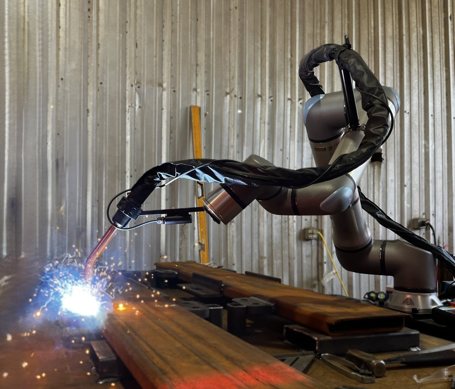 Vectis cobot welding system welding a structural steel beam at Kennedy Fabricating.