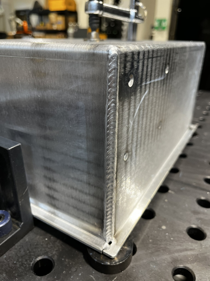 Outside-corner aluminum weld on an AL5052 fabricated assembly, showing a uniform bead profile, consistent weld appearance, and clean edges.