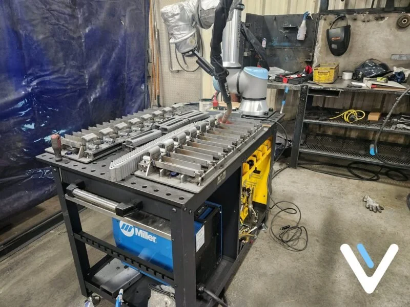 Vectis cobot welding system positioned over a fixture table at YB Welding, where the shop achieved a 5x productivity increase.
