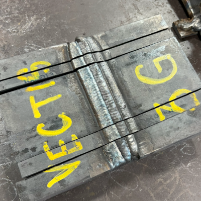3G flux core weld test plate prepared for bend testing at a heavy structural steel fabricator.