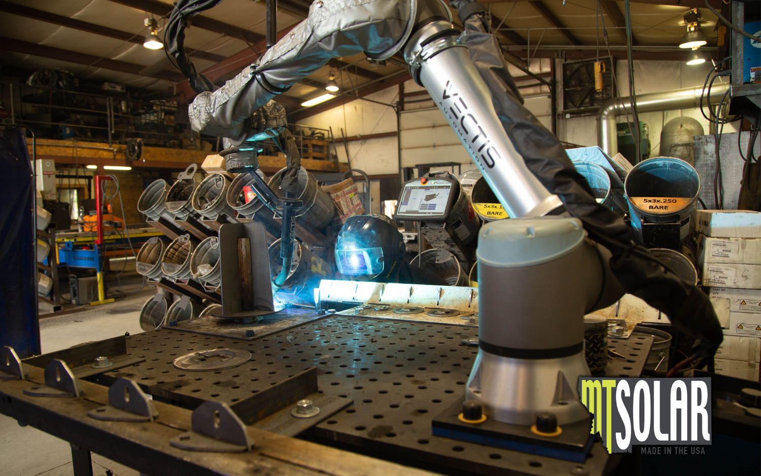Vectis cobot welding system welding a fixtured metal assembly at MT Solar.