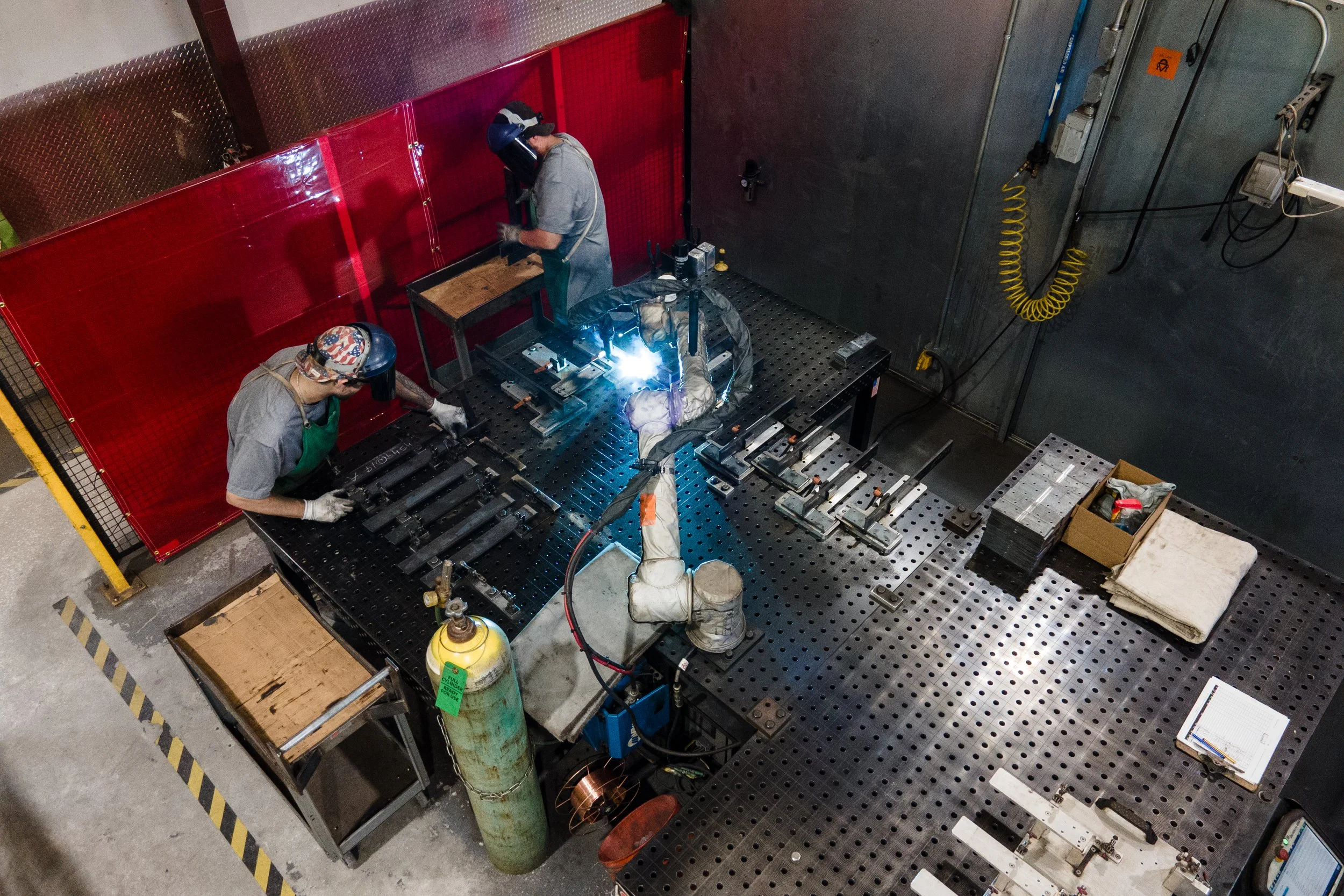 Two Centerline Brackets welders welding parts with robot