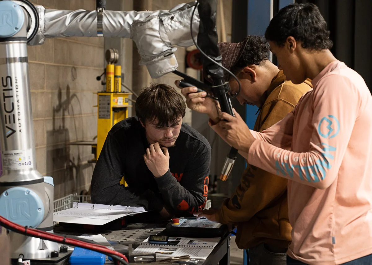 CM Welding team members working with a Vectis cobot welding system during Cobot Champions training.