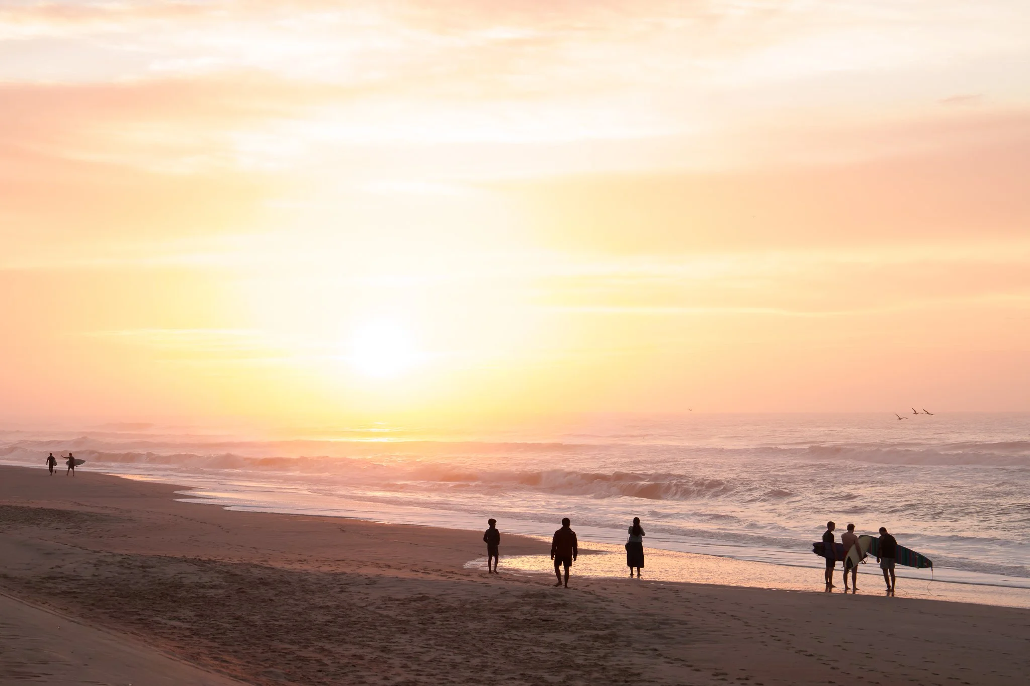 Some mornings, I find myself alone on the sand, watching the sun rise over an empty shoreline.  Other mornings, the beach hums with life.  With the promise of good surf, this morning was alive with surfers and spectators, all drawn in by the waves.

