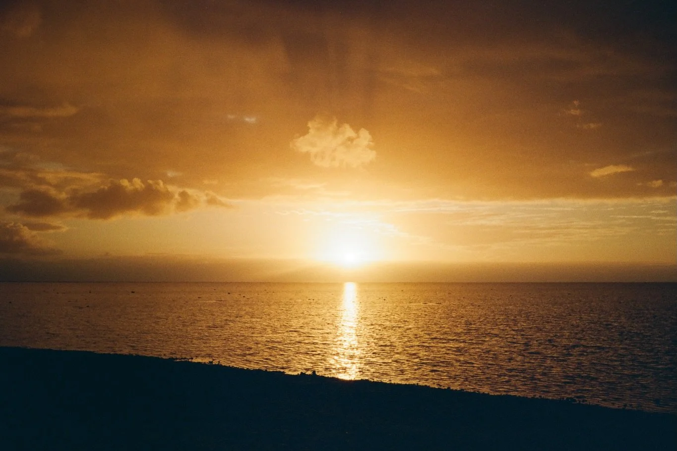 I have an old framed photo on my dresser- taken sometime in the 80s on an unknown camera with an unknown film stock by someone unidentified in my family.  In the image, the sunset hangs low and golden over the Chowan River in North Carolina.  Shot fr