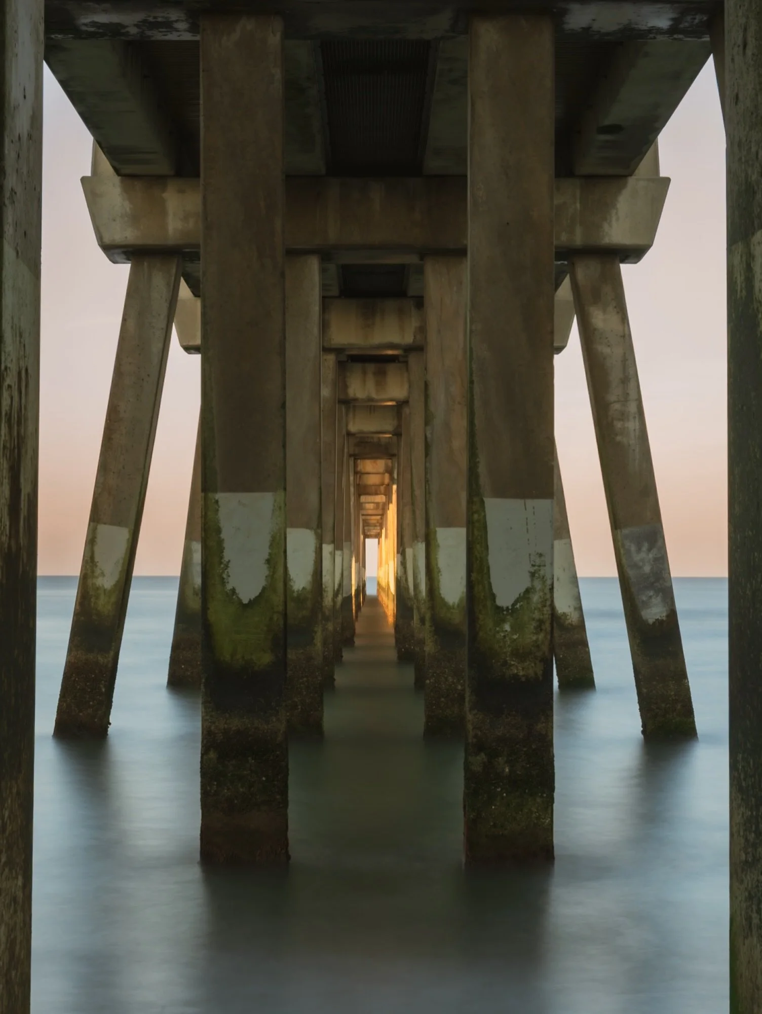 Vanishing Point

We spent golden hour under the pier working on long exposures during the Saltwater Retreat. The calm water smoothed out just right between the pilings, and I loved the way the perspective lined up straight to the sunset kissed horizo