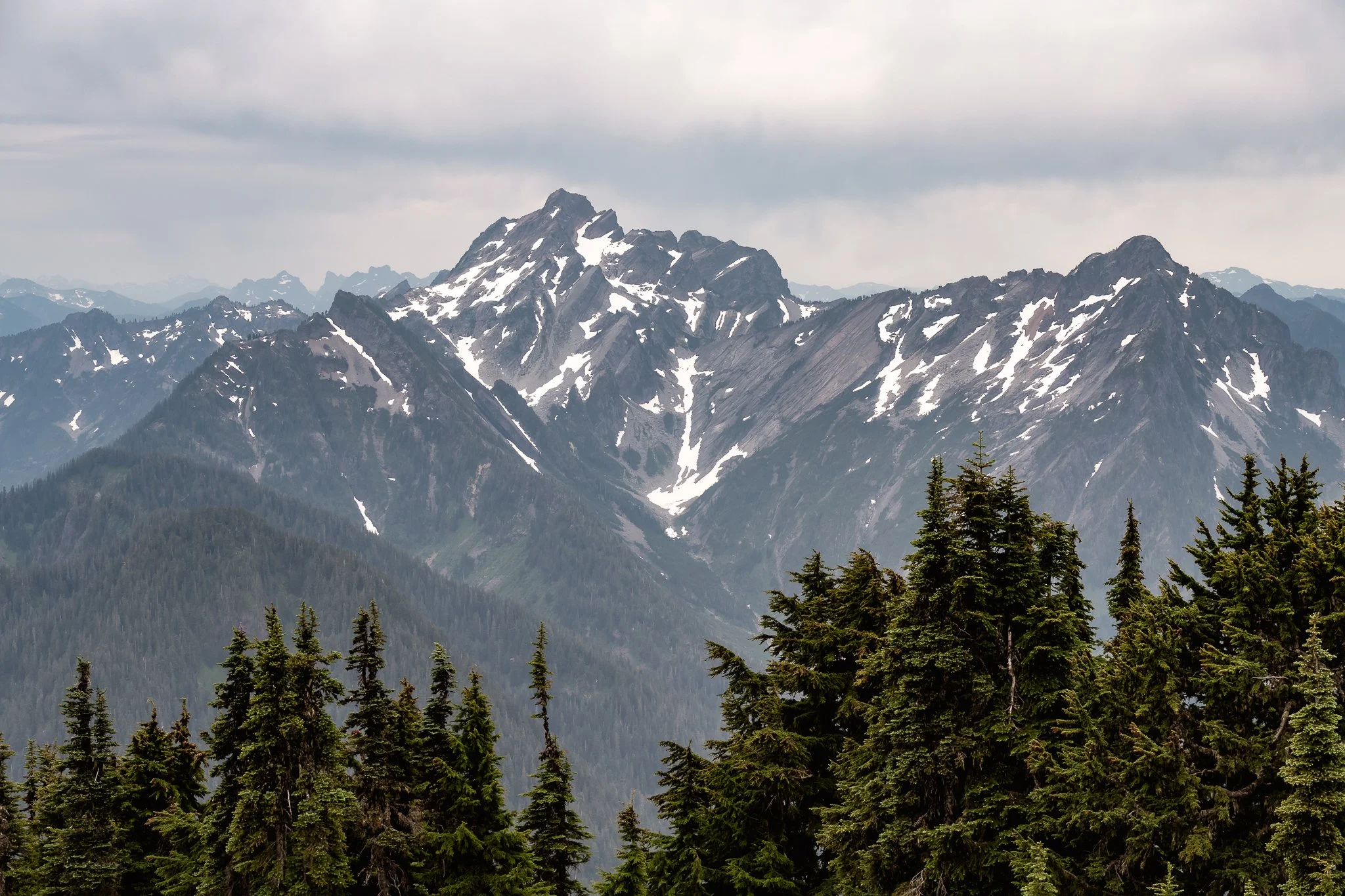 A wide view of Big Four Mountain and Hall Peak with snow patches in the North Cascades, seen from the Mount Dickerman trail.