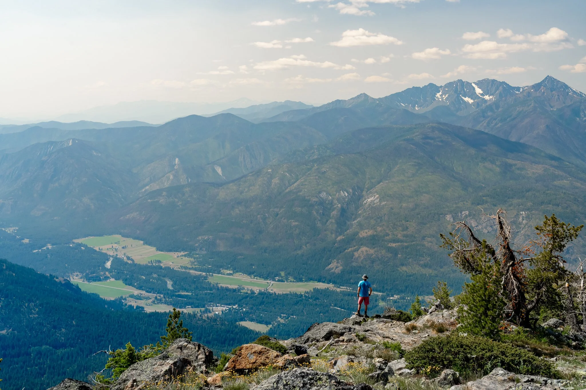 hiker overlooking methow valley from goat peak lookout