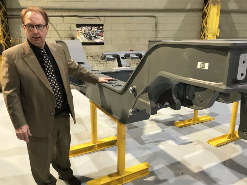 David Abshire, vice president for LB Steel in Harvey, shows a completed "truck" or "bogie" steel wheel assembly that will become part of a new high-speed train. (Ted Slowik/Daily Southtown)